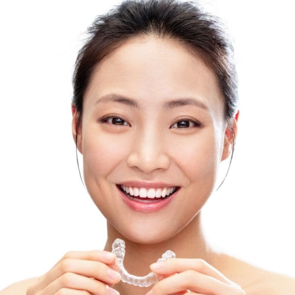 A woman with an Invisalign in her hands 